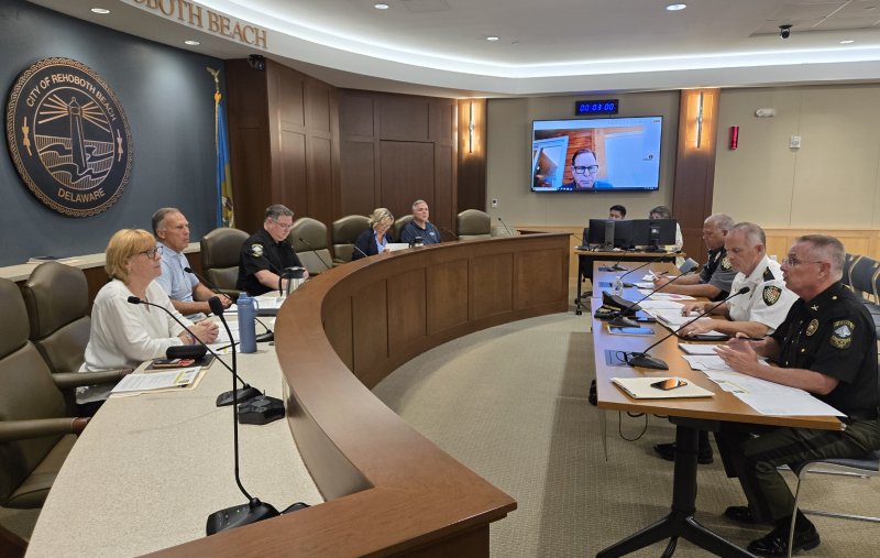 The Rehoboth Beach/Lewes Police Accountability Committee held its first meeting June 24 in Rehoboth Beach City Hall. Pictured front to back at the table on the left are committee members Kim Leisey, Dan Zagchem, Rehoboth Beach Police Lt. Mark Sweet, Mary Good and Dan DeSimone. Front to back at the right-hand table are Rehoboth Beach Police Chief Keith Banks, Lewes Police Chief Thomas Spell and Lewes Police Deputy Chief James Locklear. Pictured onscreen in the back is member Andrew Glassman. Not pictured is committee member Rev. Eddie Jusino. CHRIS FLOOD PHOTO